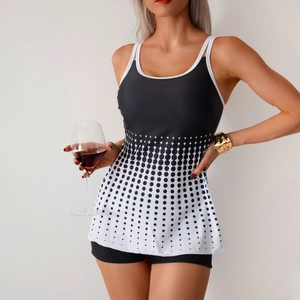Women's tankini swimsuit set with black and white polka dot top and boyleg bottoms
