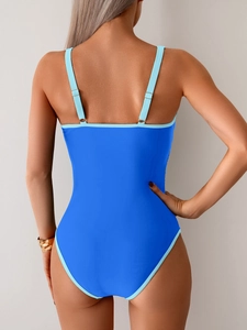 Back view of bright blue one-piece swimsuit featuring open back and adjustable straps