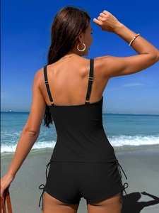 Rear view of black two-piece sporty swimwear featuring adjustable straps and drawstring boy shorts