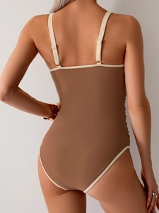Deep U-neck back view of a mocha brown one-piece swimsuit with white trim and ruching