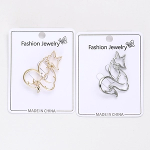 Detail view of fox-shaped alloy brooches in gold and silver with hollow design