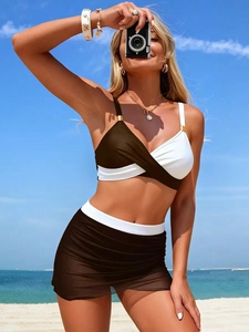 Detail of black and white mesh skirt bikini with crossover wrap top and metallic buckles