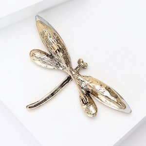 Detail view of the vintage gold dragonfly brooch back with secure rotating safety pin