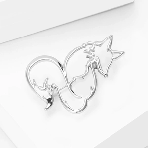Close-up of hollow fox brooch in polished silver-tone alloy with minimalist abstract lines