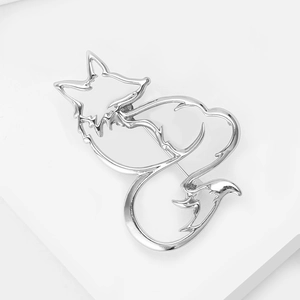 Detailed view of silver hollow fox brooch with abstract metal lines and polished finish