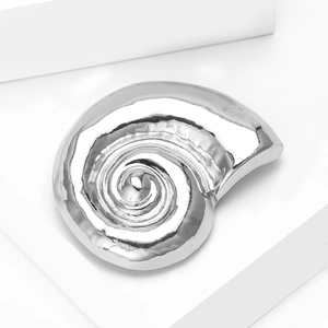 Polished silver snail shell brooch detail with reflective mirror finish and spiral texture