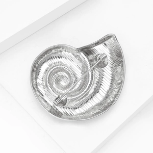 Detailed back view of silver snail shell brooch showing pin closure and spiral texture