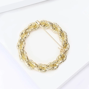 Detailed close-up showing the twisted rope texture and gold finish of the alloy brooch pin