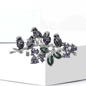 Exquisite silver bird brooch with colorful crystals on a branch, elegant nature jewelry