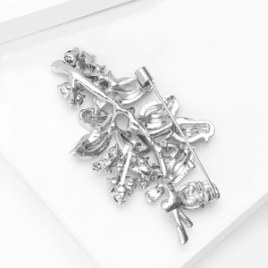 Macro shot of silver alloy brooch back showing safety pin clasp and hollow structure