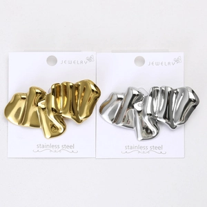 Detailed macro view of gold and silver irregular wave textured stainless steel pins