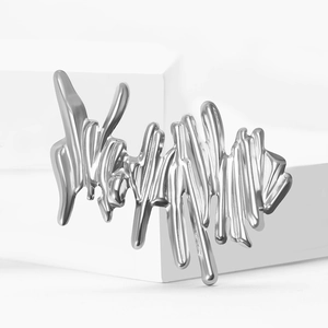 Unique silver stainless steel brooch featuring a liquid metal graffiti wave design