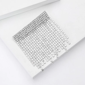 Detailed macro view of cascading rhinestone tassel brooch with elegant silver-tone finish