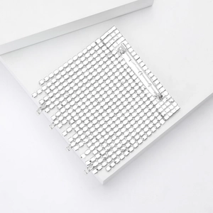 Detail of silver square rhinestone brooch with sparkling crystal array and metal pin back