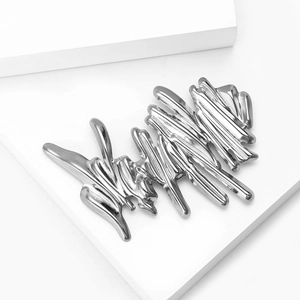 Macro shot of abstract liquid metal silver brooch with wavy avant-garde design
