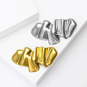 Minimalist wavy textured metal brooches in gold and silver finish with a fluid design