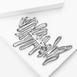 Detailed back view of a silver wavy brooch showing secure safety pin clasp closure