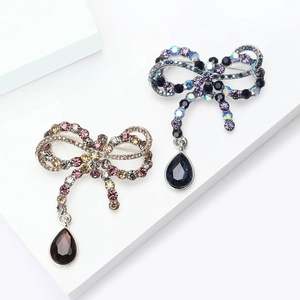 Vintage bowknot brooch with shimmering rhinestones and waterdrop pendant for women