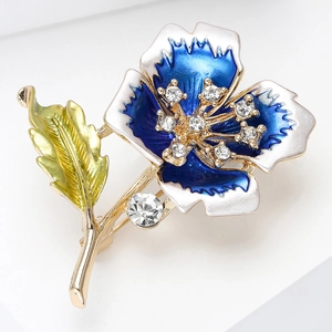 Macro detail of enamel flower brooch with sparkling cubic zirconia and golden finish