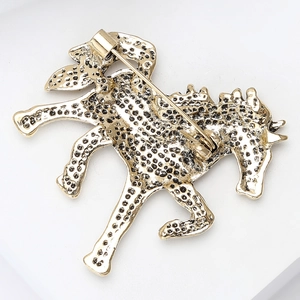 Detail view of the vintage horse brooch back featuring a secure pin clasp and textured finish