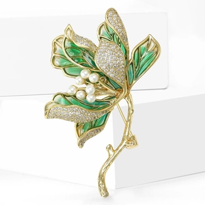 Elegant gold lotus flower brooch with green enamel leaves, pearls and sparkling rhinestones