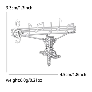 Musical cat brooch with treble clef notes and crystal accents measuring 3.3cm by 4.5cm