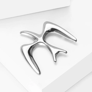 Detailed macro view of a silver swallow bird brooch with mirror polished finish