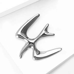 Polished silver stainless steel swallow brooch with minimalist bird design details