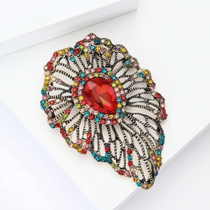 Vintage Baroque brooch with a red teardrop crystal and colorful rhinestones on bronze base