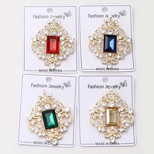 Detail view of four vintage palace style brooches with colorful crystals and alloy base