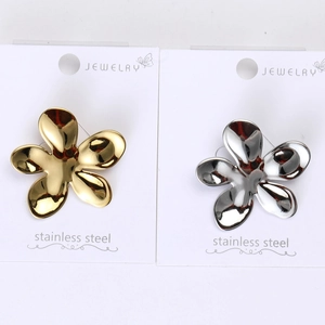 Detailed close-up of gold and silver liquid metal flower brooches on jewelry cards