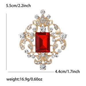 Detail view showing dimensions 5.5x4.4cm of a vintage gold brooch with red gemstone
