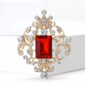 Exquisite vintage royal glass brooch with large red stone and golden filigree design