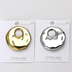 Detail of liquid metal texture on gold and silver stainless steel irregular brooches