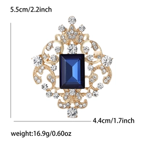 Detail view of vintage glass brooch with blue gemstone and dimensions 5.5cm x 4.4cm