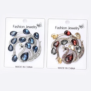 Detail view of peacock brooches with sparkling crystals and elegant alloy base plating