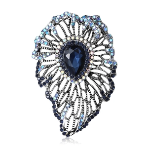 Vintage silver brooch with teardrop blue crystal and rhinestones in hollow floral design