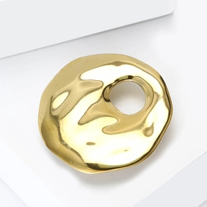 Golden minimalist irregular hollow brooch with liquid metal texture on white background