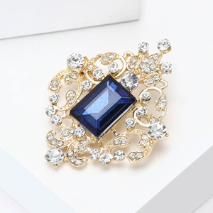 Detail of vintage palace brooch with rectangle blue gemstone and white rhinestones