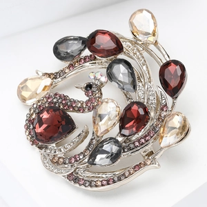 Close-up of luxury peacock brooch with colorful teardrop crystals and silver alloy plating