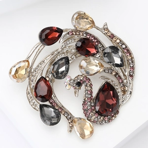 Detailed shot of a peacock brooch with colorful teardrop gems and silver metal base