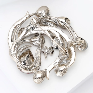 Detailed back view of the silver vine brooch showing the pin mechanism and metal texture