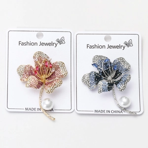 Detailed view of luxury hibiscus flower brooches with colorful rhinestones and pearls