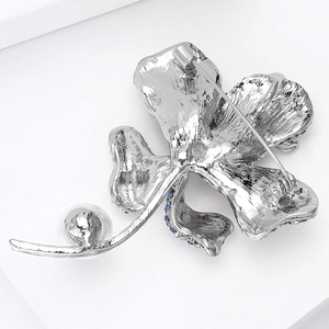 Detailed back view of a silver floral brooch with a pearl and secure pin closure mechanism