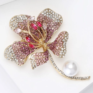 Macro shot of hibiscus flower brooch with pink crystals and large white pearl detail