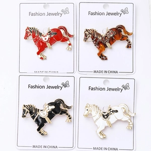 Macro detail of alloy horse brooches in four colors with colorful enamel and rhinestones