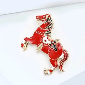 Detailed macro shot of a galloping horse brooch with red enamel and gold trim