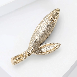 Detailed back view of gold leaf brooch showing secure rotating safety pin clasp