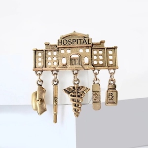 Vintage gold hospital medical brooch with pharmacy pendants and Rx symbol detail