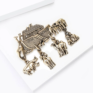 Detailed macro view of vintage bronze Noah's Ark brooch with animal charms dangling